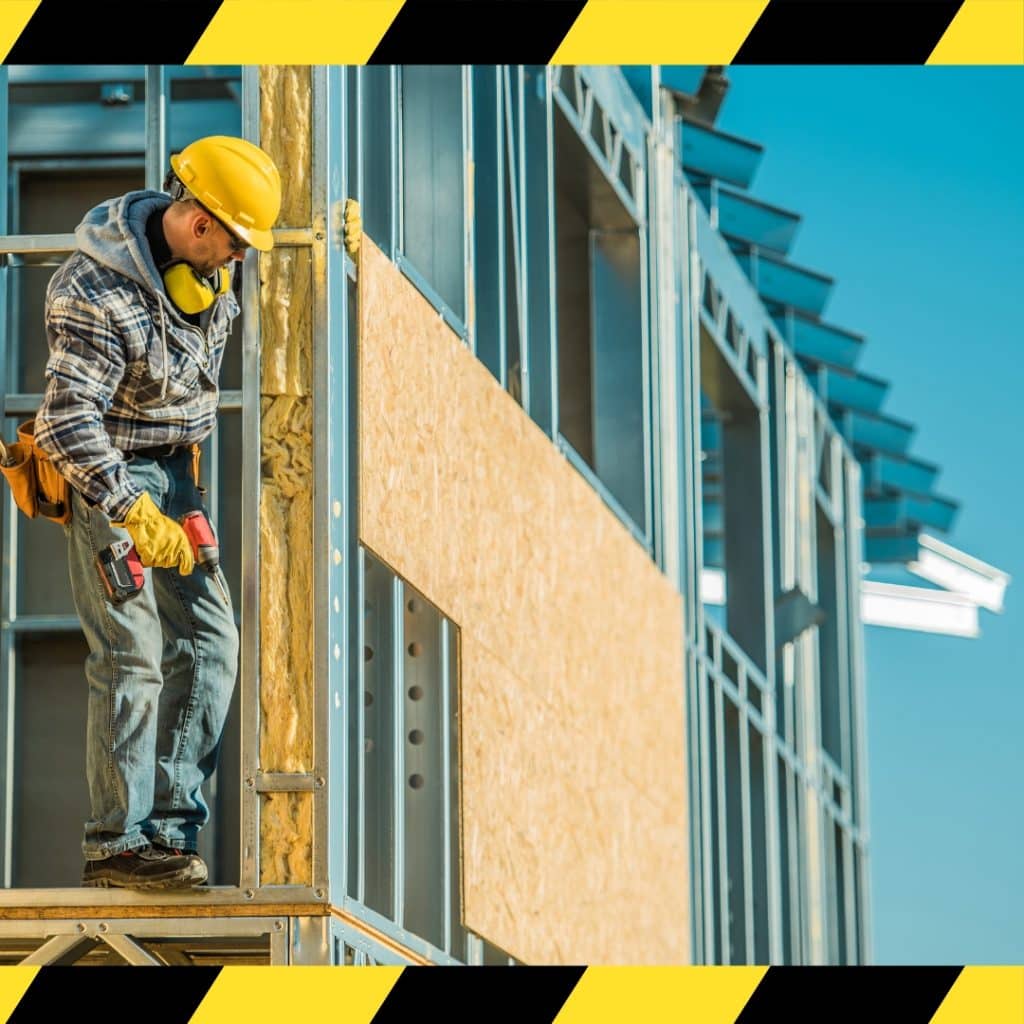 A construction worker wearing a yellow safety helmet and harness while using a ladder highlighting safety measures taught in the Work Safely at Heights training course in Sydney.