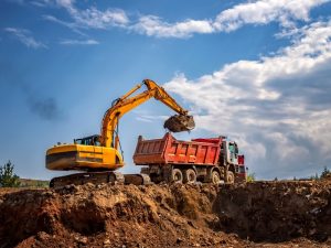 Excavator excavating soil, highlighting essential excavator safety features for safe and compliant construction site operations in Australia.