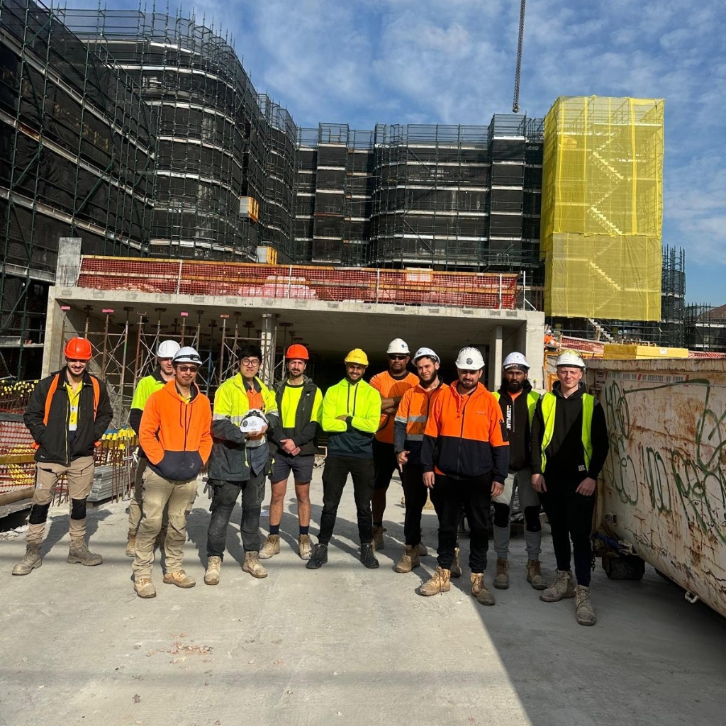 Traffic Controller Skill Set group of construction workers posing in high-visibility safety gear at an active building site.