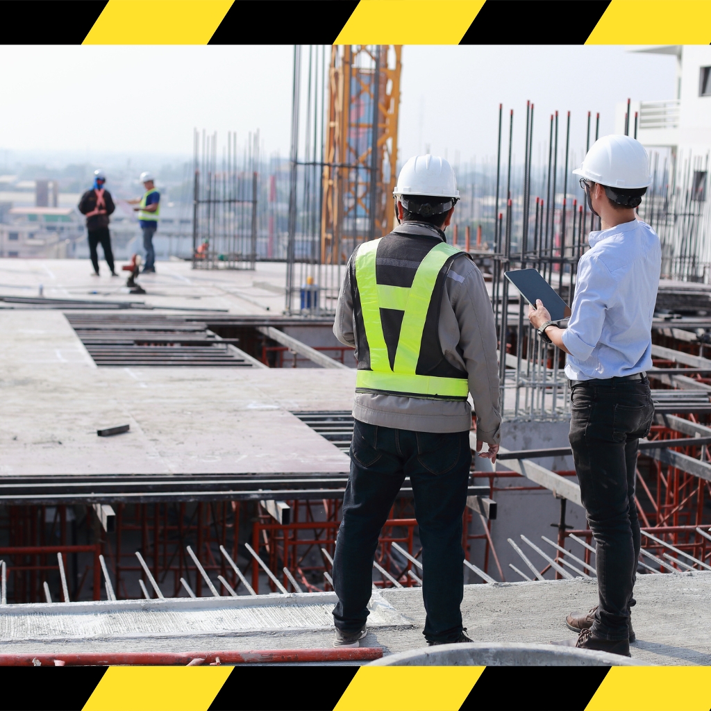 Traffic Controller Skill Set training on-site with workers wearing safety gear and monitoring construction progress using a tablet.