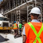 Workers undergoing site inductions, familiarising themselves with the layout of the construction site to ensure safety and efficiency.