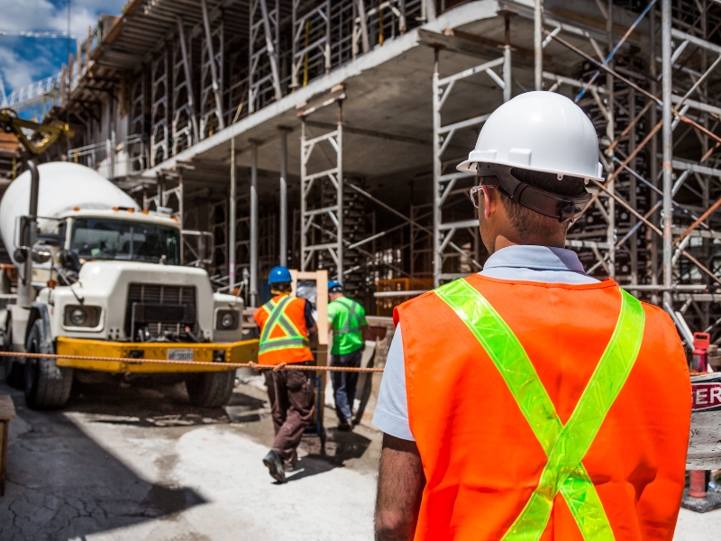 Workers undergoing site inductions, familiarising themselves with the layout of the construction site to ensure safety and efficiency.